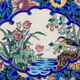 Assiette Longwy 1930 – Émaux à décor d’oiseaux et fleurs oranges