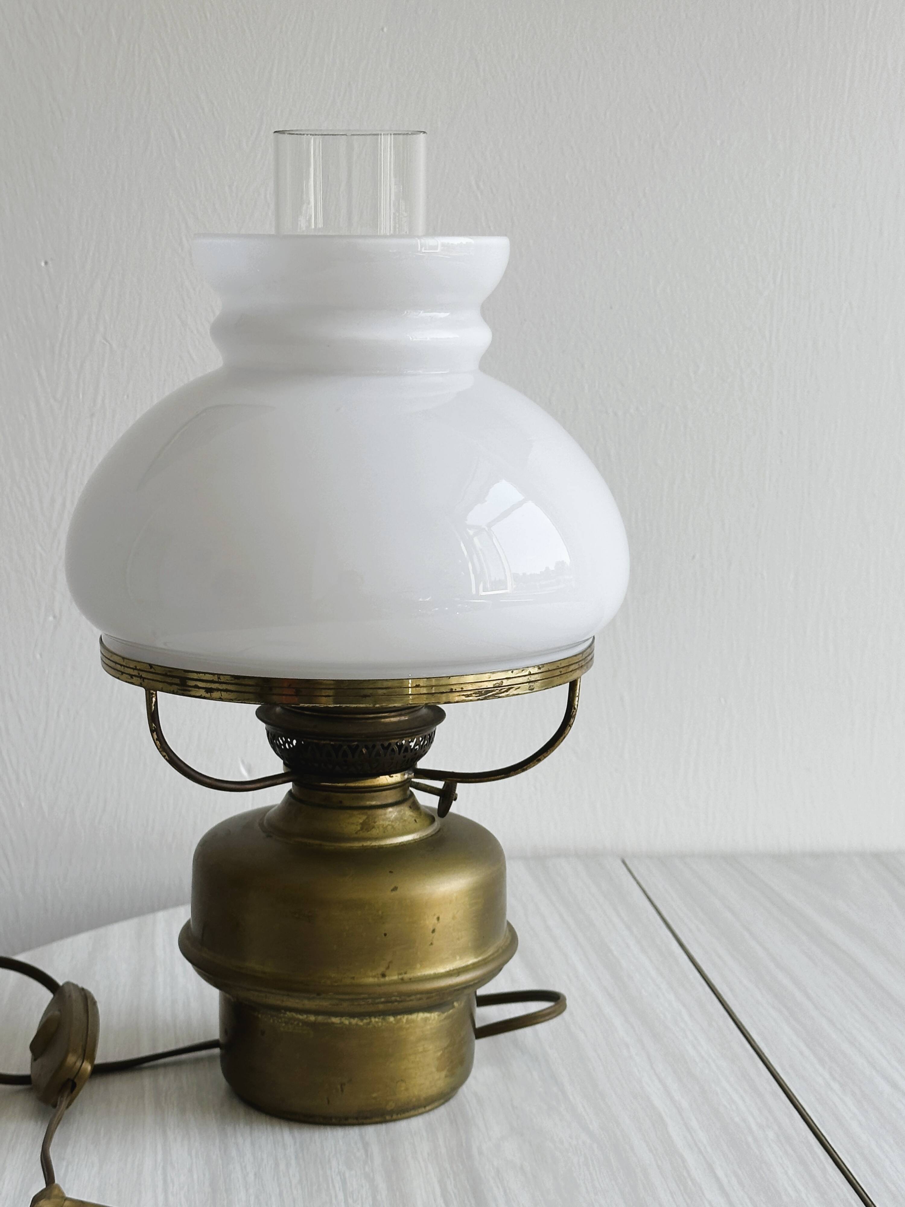 Vintage brass lamp with white opaline glass shade.