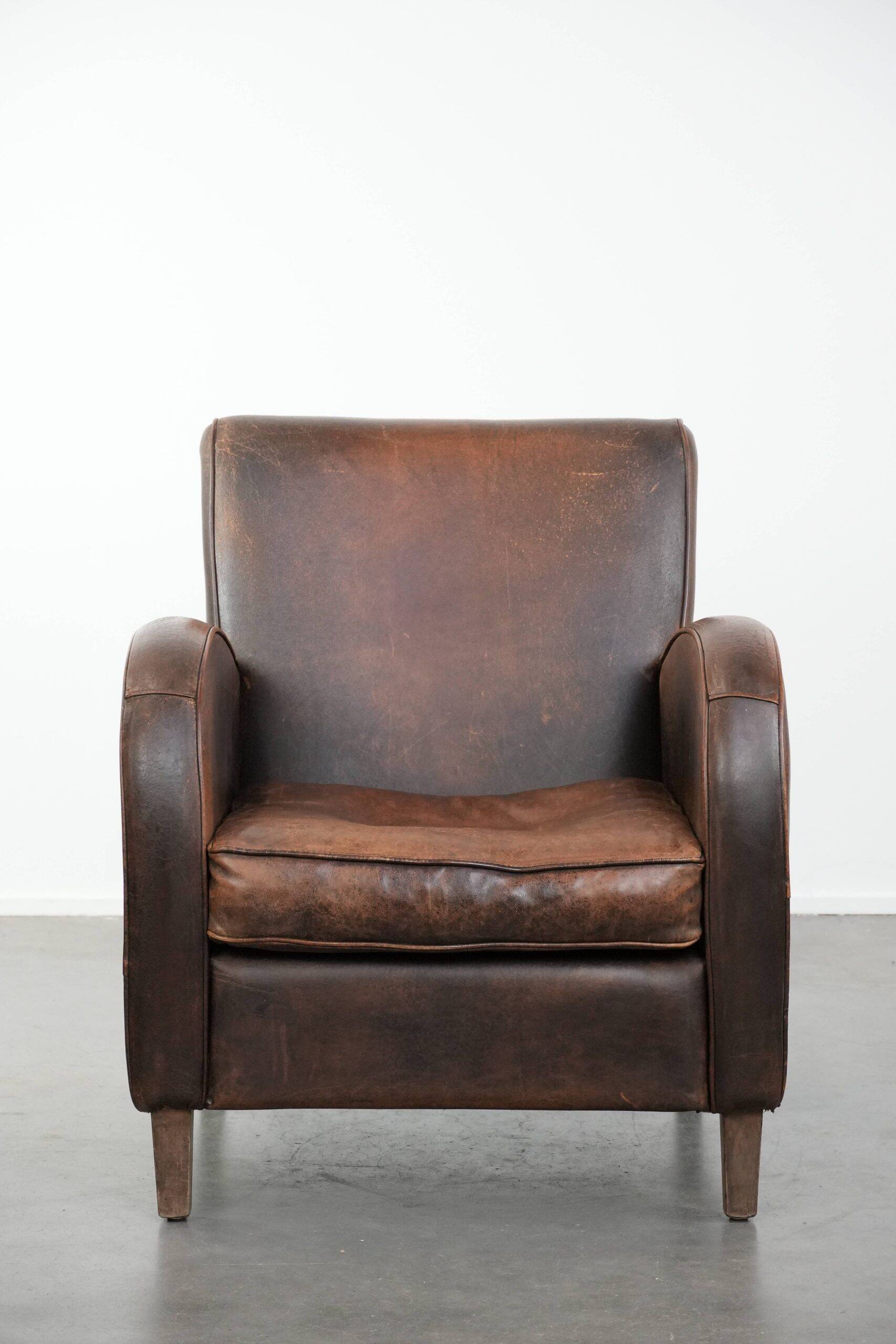 Vintage sheepskin leather design armchair in a dark cognac colour