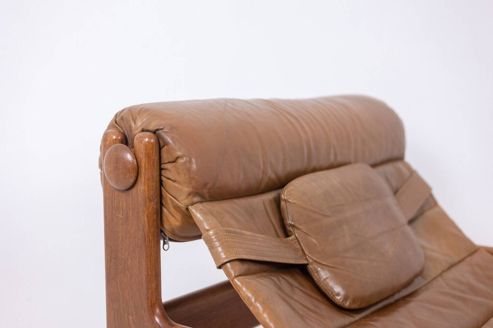 Lounge chair and ottoman, in blond elm and leather. 1970s