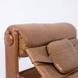 Lounge chair and ottoman, in blond elm and leather. 1970s