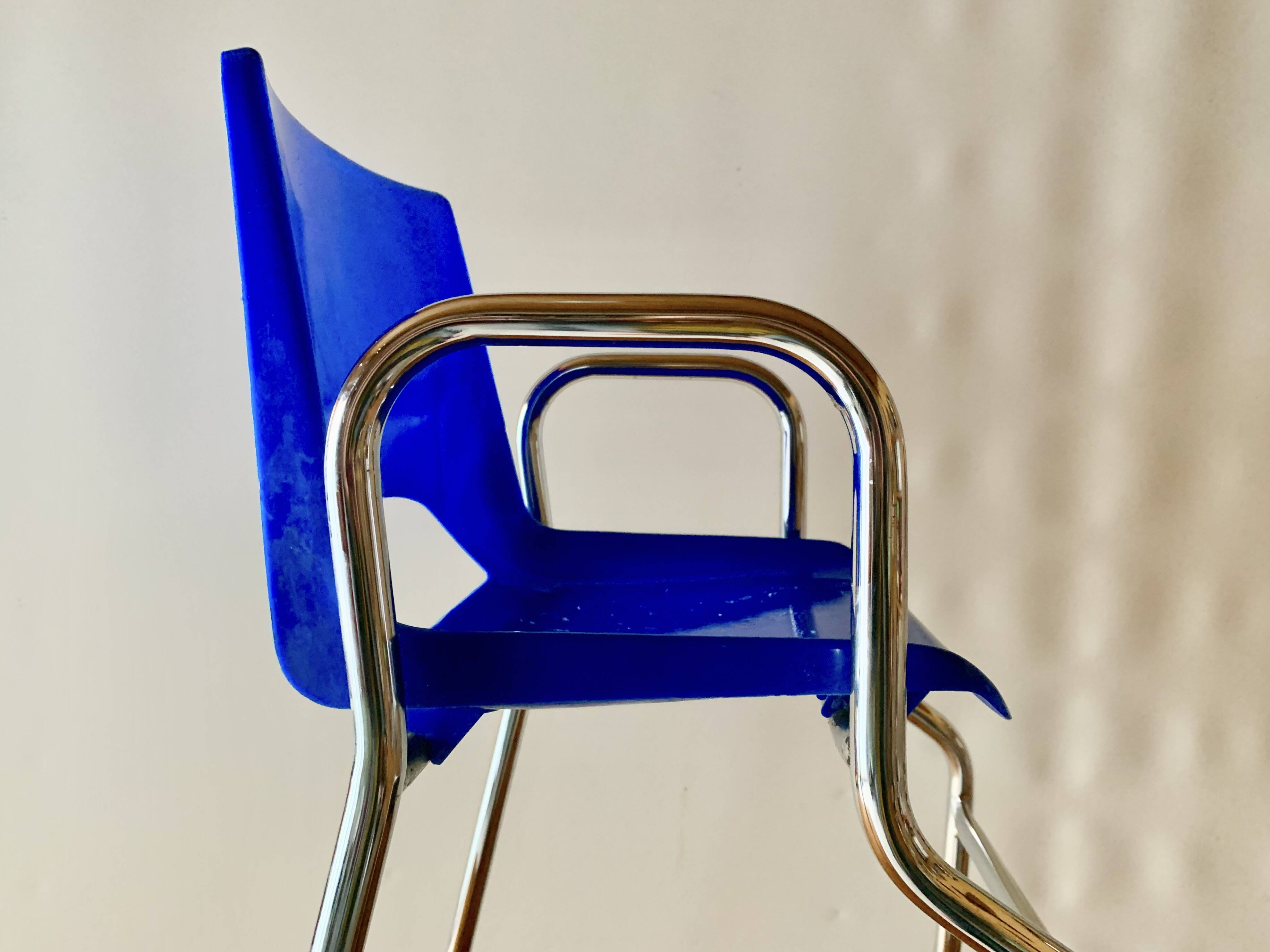 Vintage high chair for children in chrome metal and blue plastic