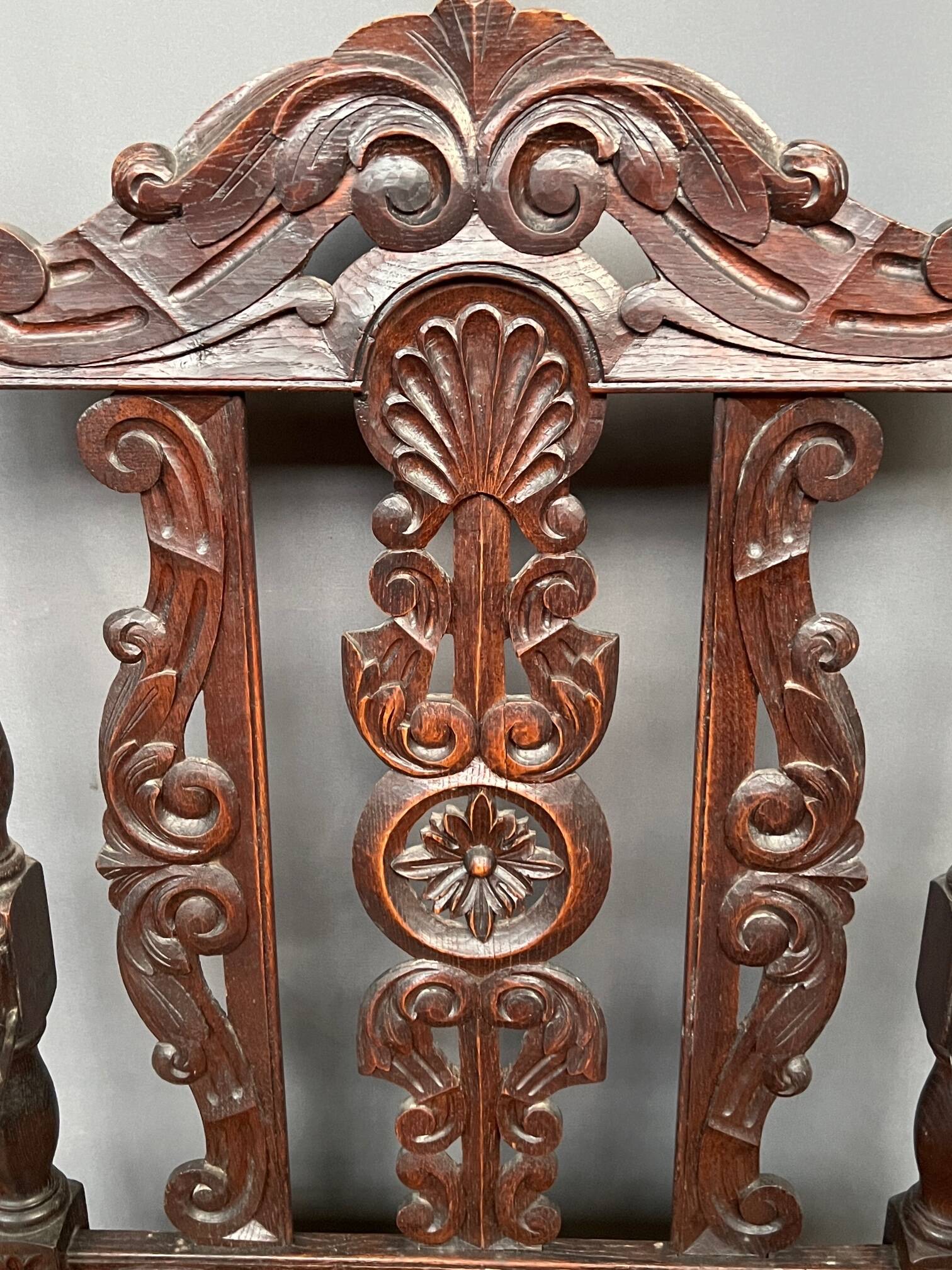 Renaissance-style oak armchair, hand-carved deep sculpture.