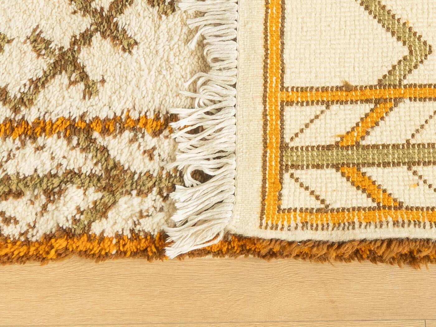 XXL Berber rug with long fringes from the 1960s. Cream-coloured pile with patterns in orange and green tones.