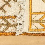 XXL Berber rug with long fringes from the 1960s. Cream-coloured pile with patterns in orange and green tones.