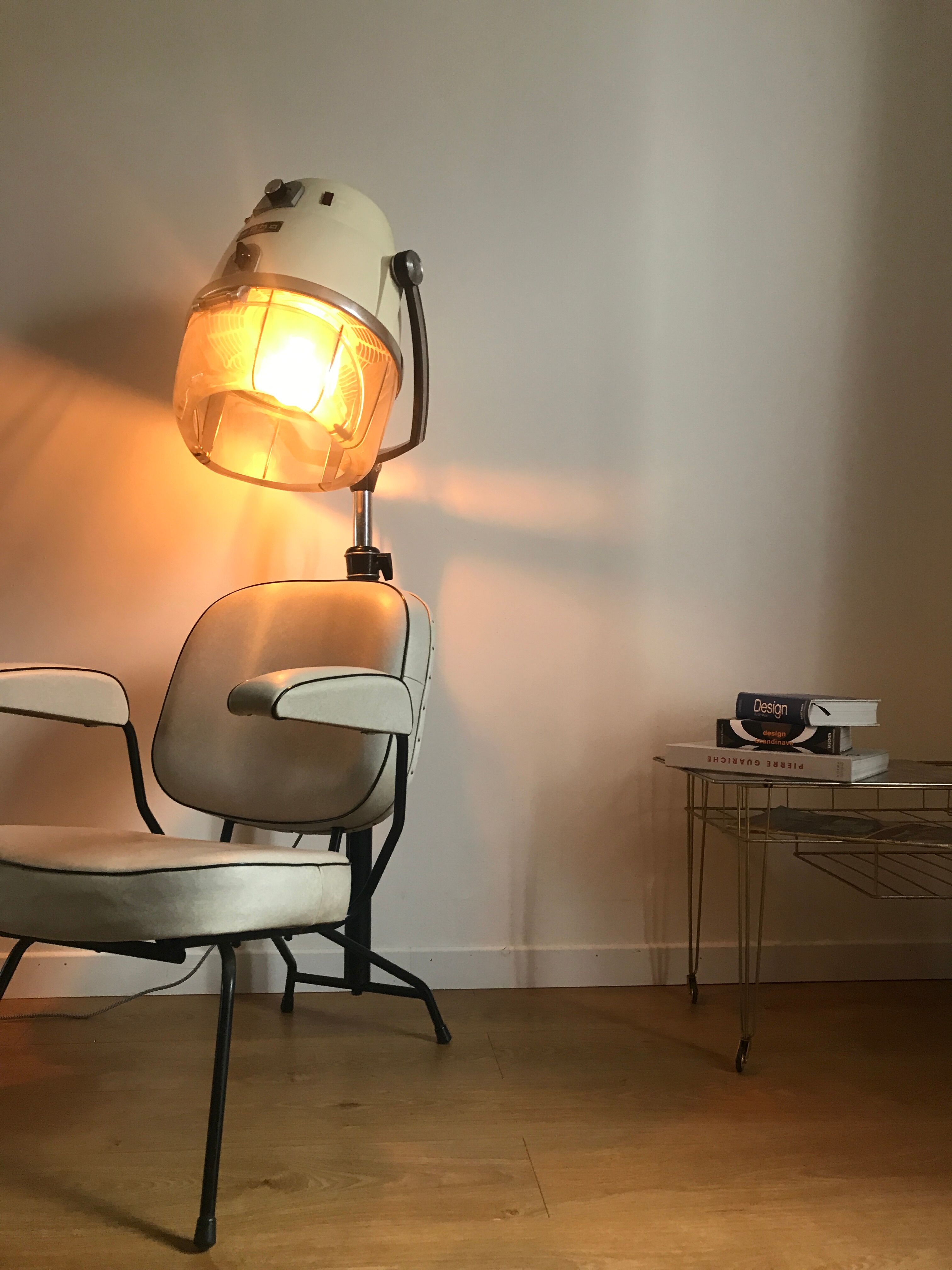 Vintage hairdresser's armchair with helmet transformed into a lamp