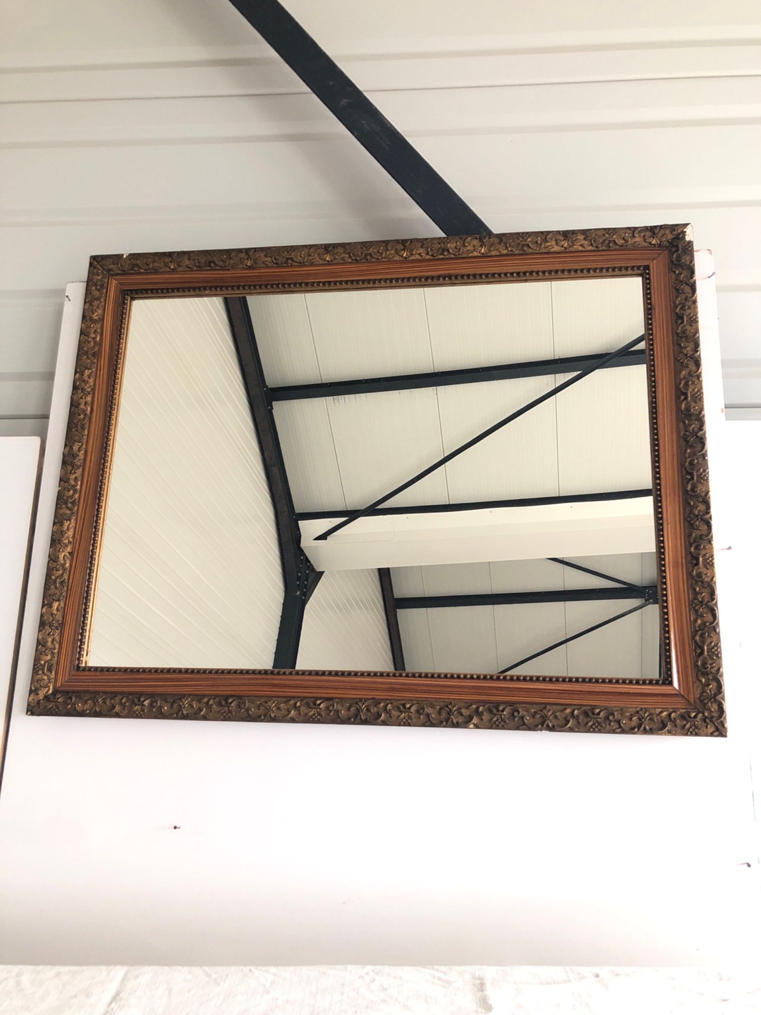 Old mirror with wooden frame and plaster moldings