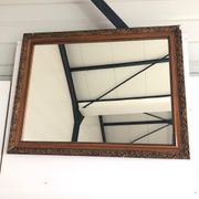 Old mirror with wooden frame and plaster moldings