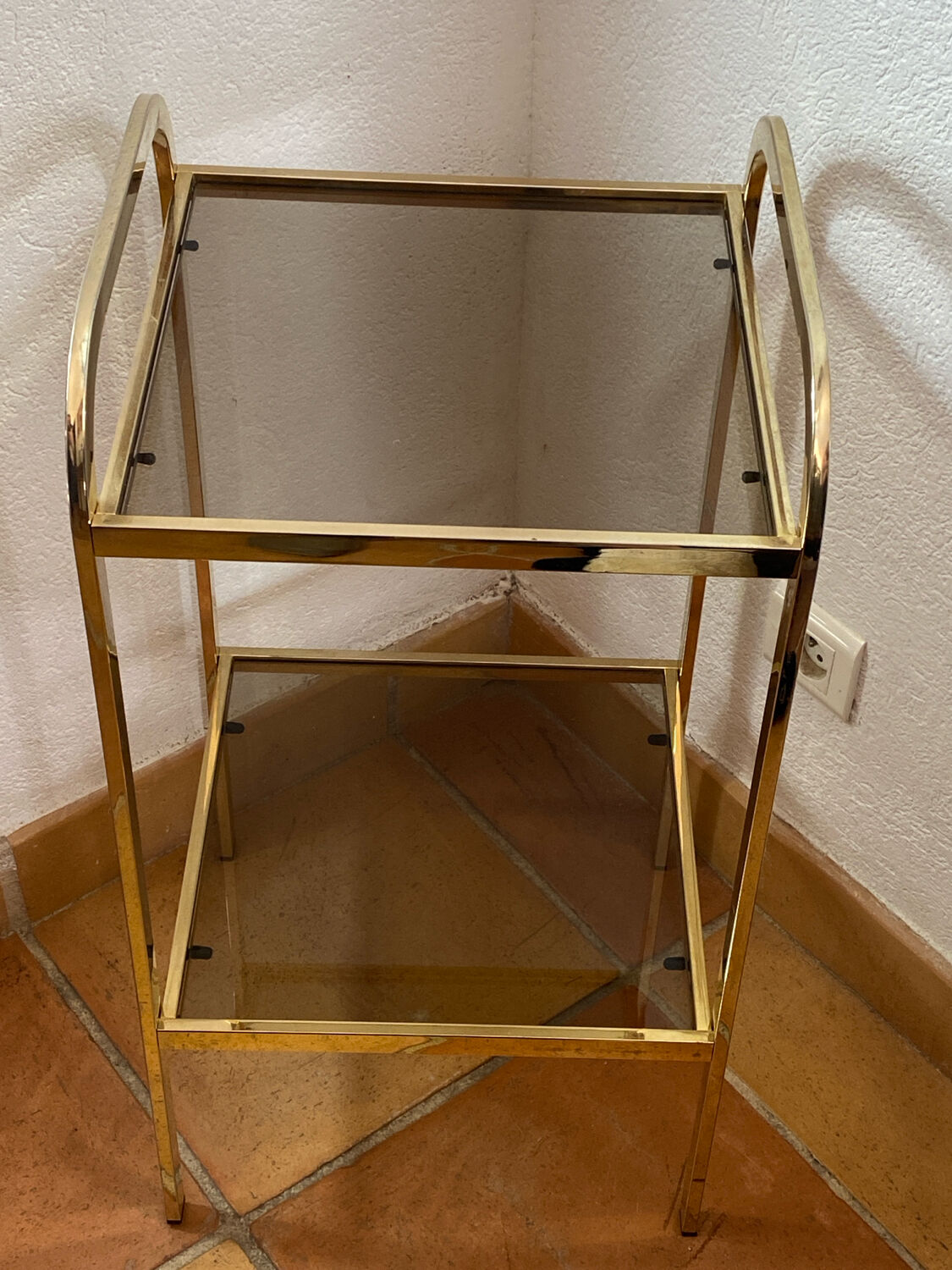 Gold metal and smoked glass console table.