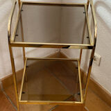 Gold metal and smoked glass console table.