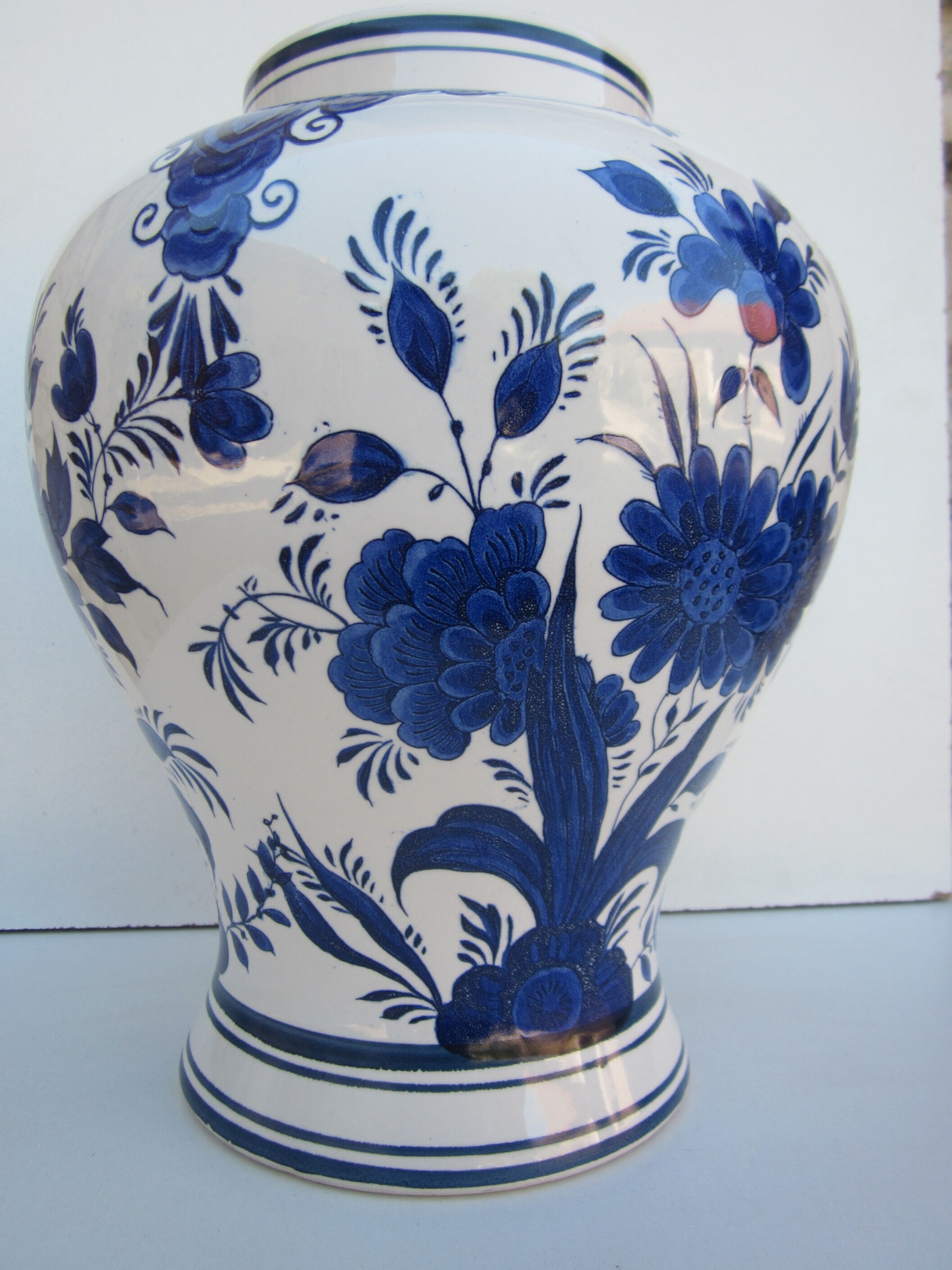 Ceramic vase earthenware, blue floral decoration on a white background