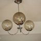 Chrome metal chandelier with smoked glass globes.