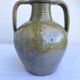 Ancient oil jar in glazed terracotta, khaki green — Auvergne, Lezou