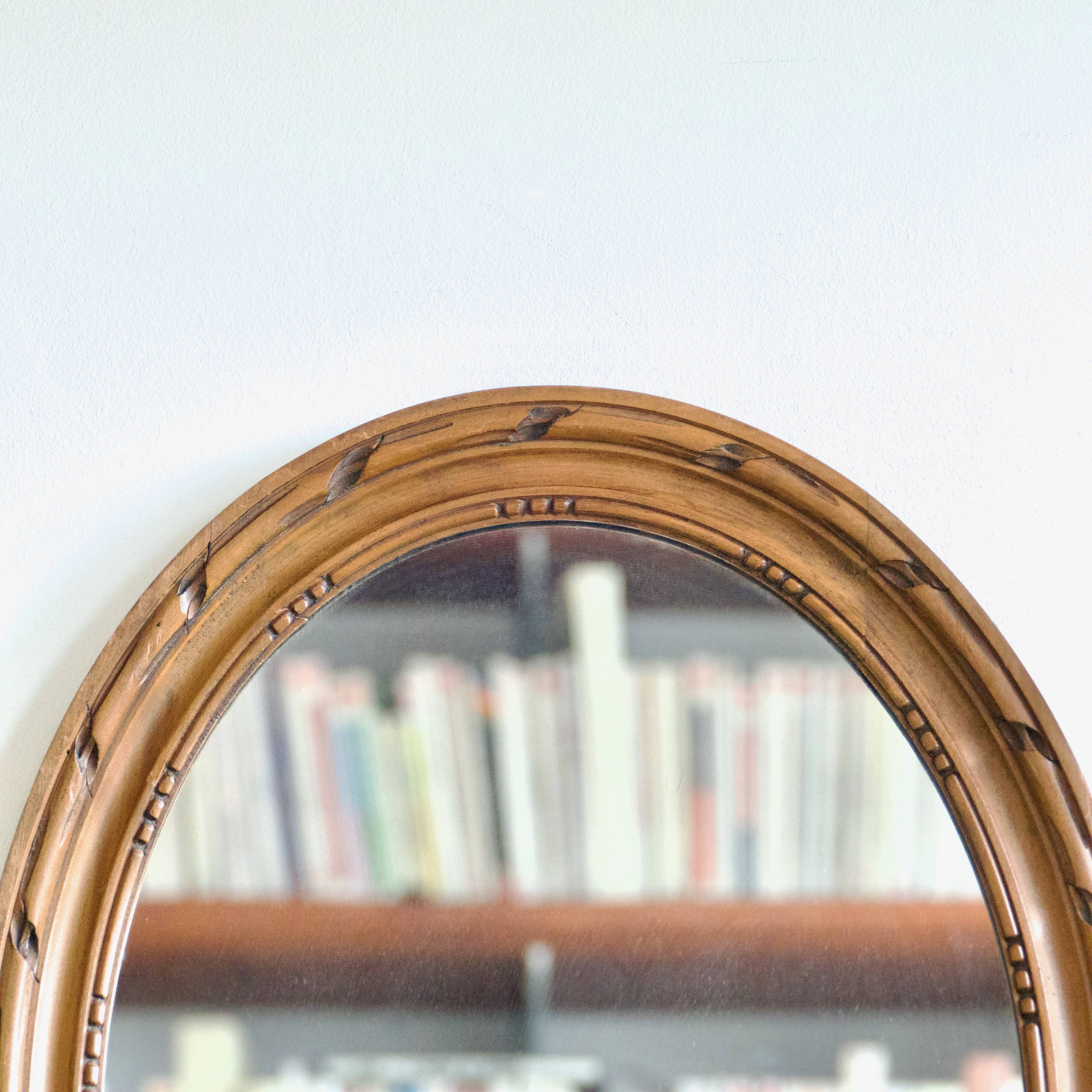 Antique oval mirror in carved wood