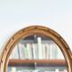 Antique oval mirror in carved wood