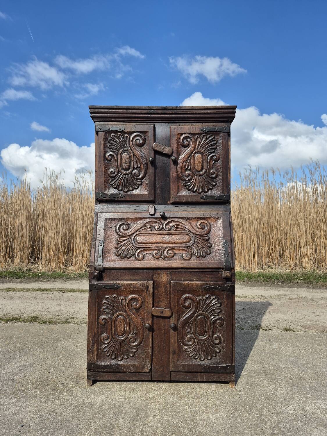 antique cabinet with carvings and wrought iron fittings rural