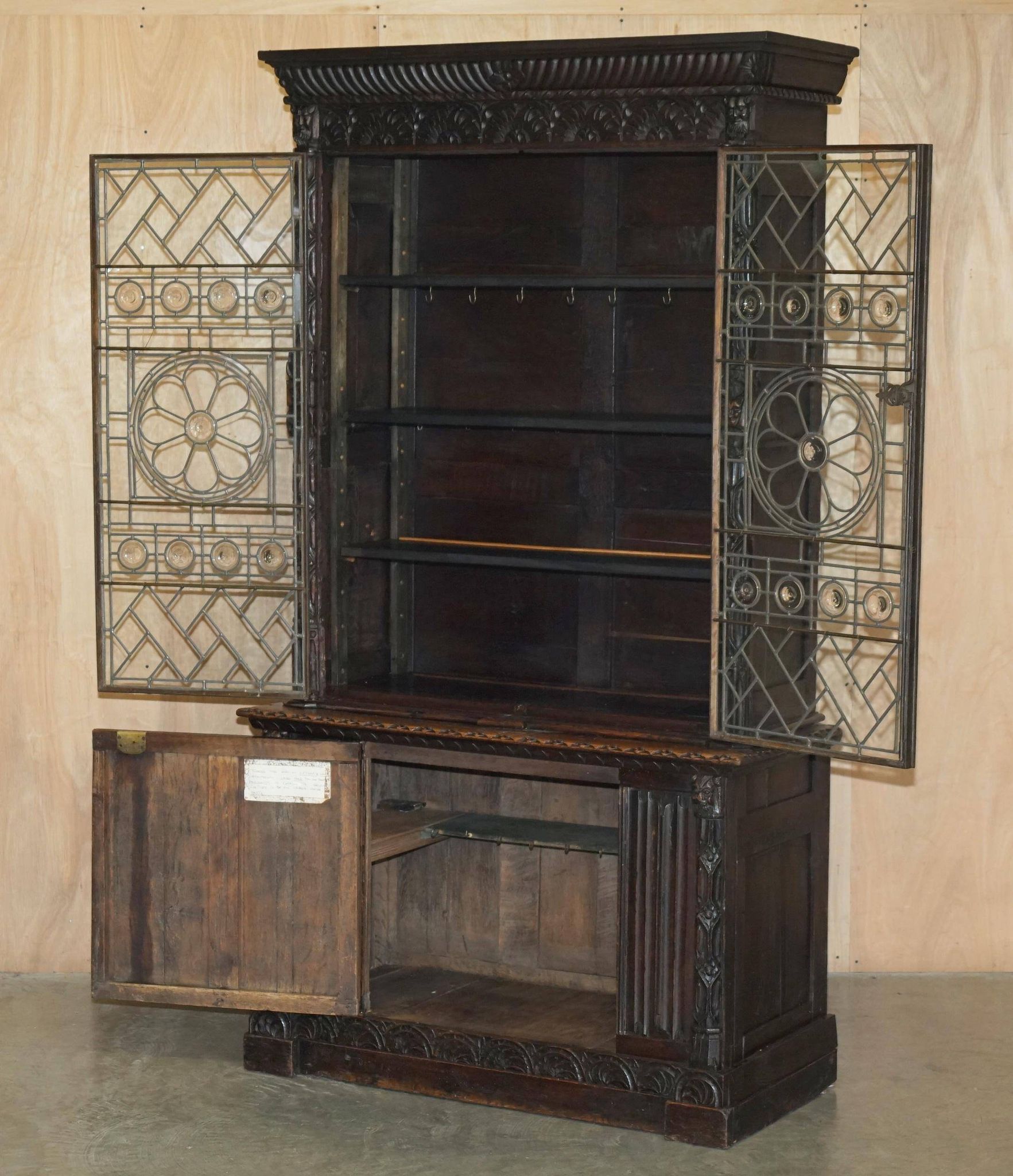 Jacobean hardwood library with carved panels and glass doors.