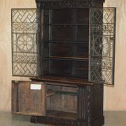 Jacobean hardwood library with carved panels and glass doors.