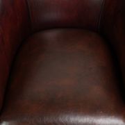 Vintage sheepskin club armchair with decorative nails and black piping