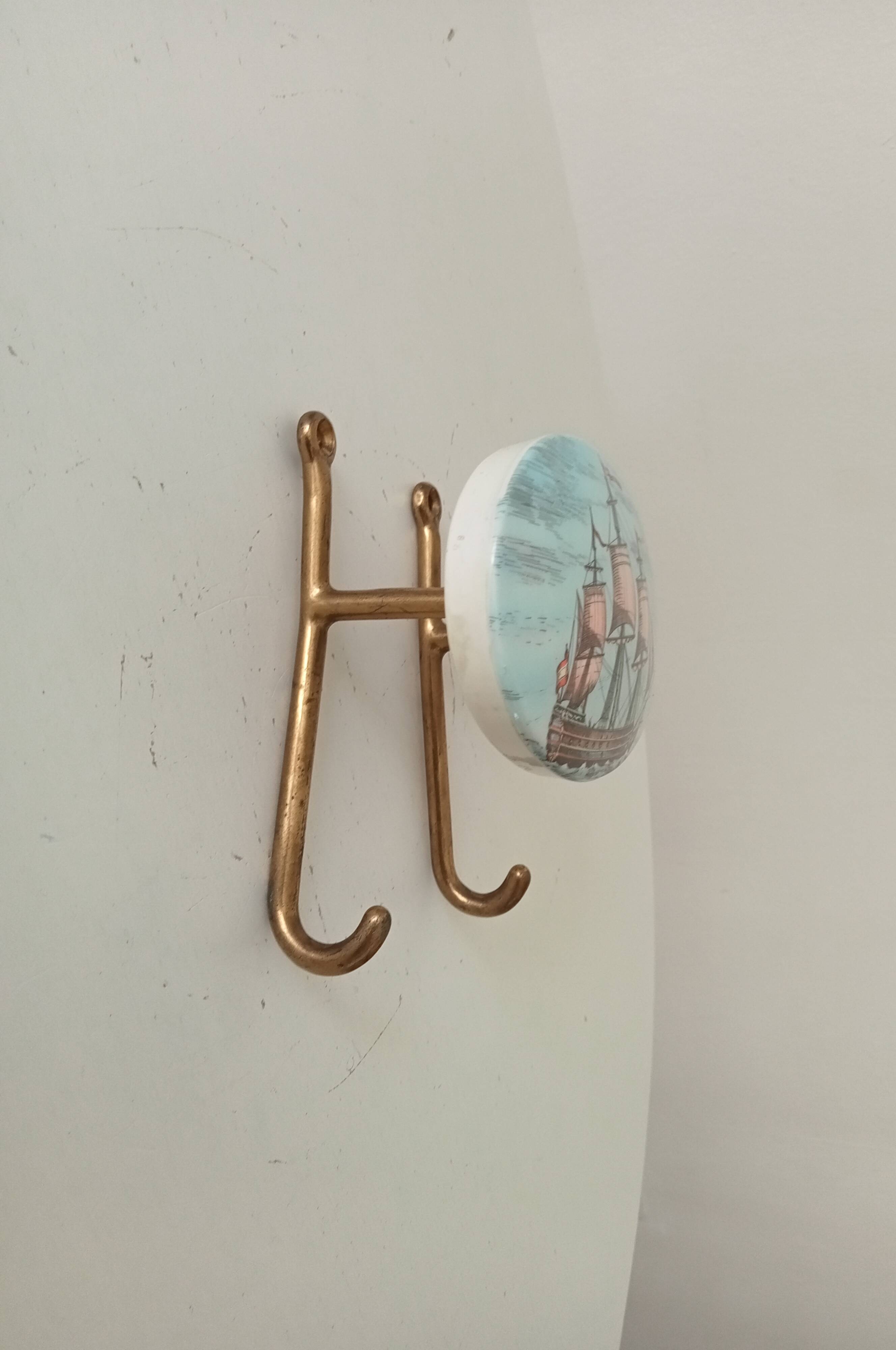 Vintage wall coat hook in brass and Bakelite.