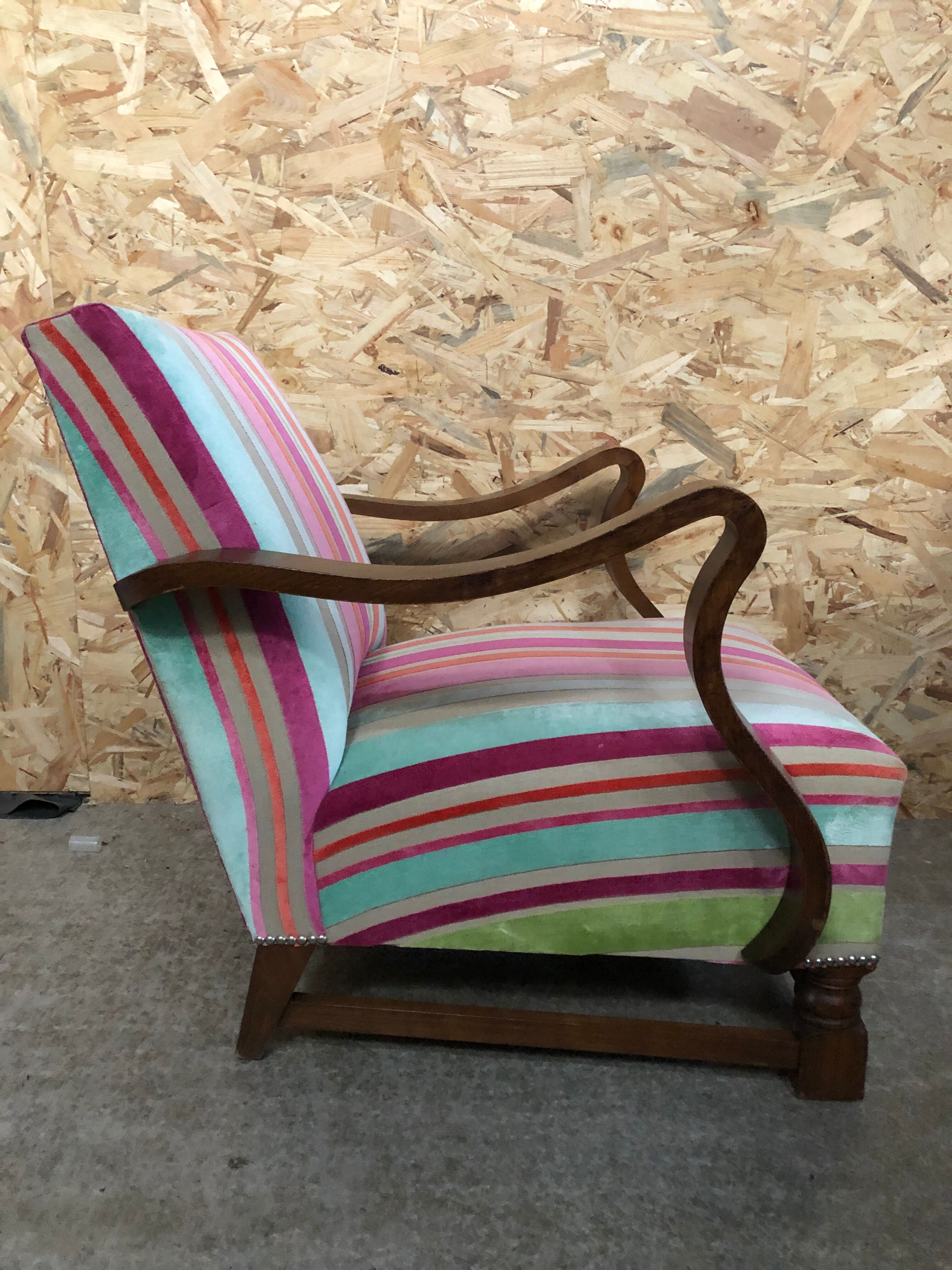 Old wooden armchair with curved armrests
