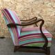 Old wooden armchair with curved armrests