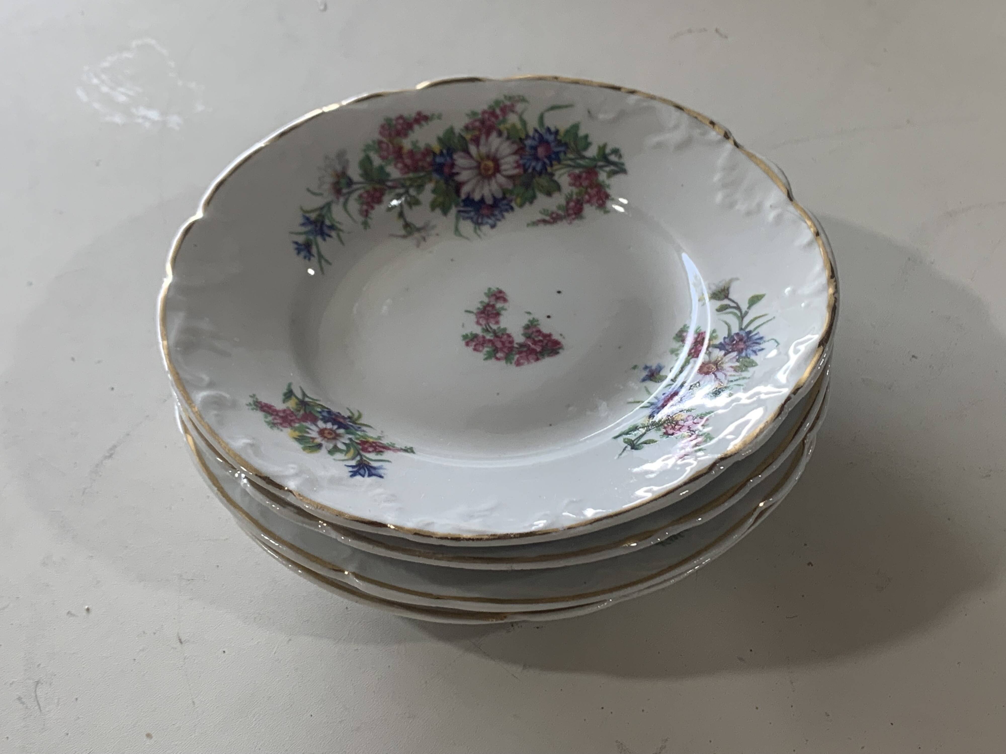 4 vintage porcelain saucers