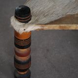 Vintage African artisanal stool, triangular shape with 3 legs, cowhide, 20th century.