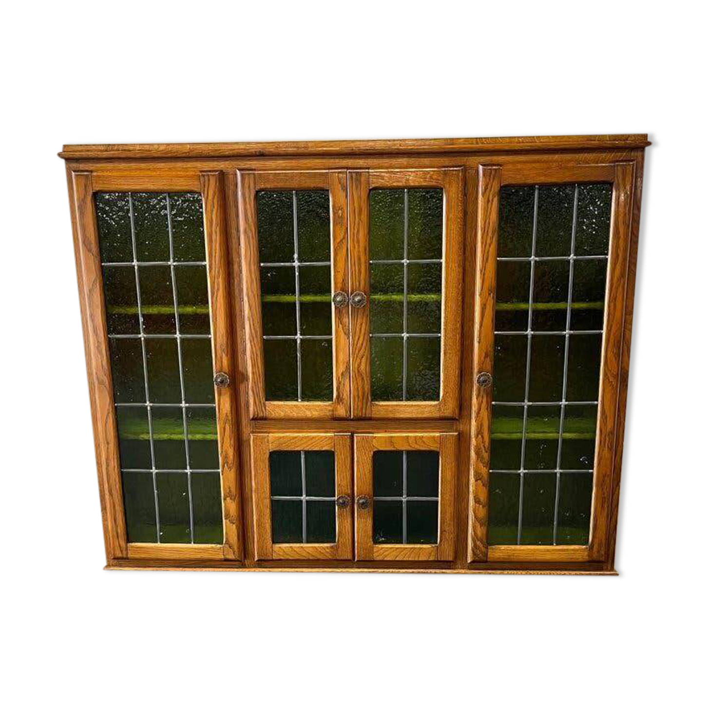 Vintage wall-mounted wooden cabinet with green stained glass.