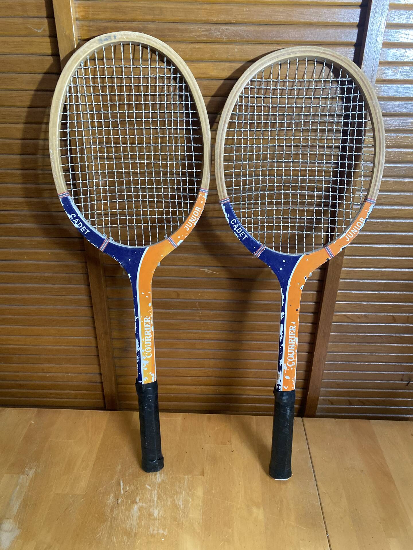 Pair of vintage wooden tennis rackets for cadet junior sport courier