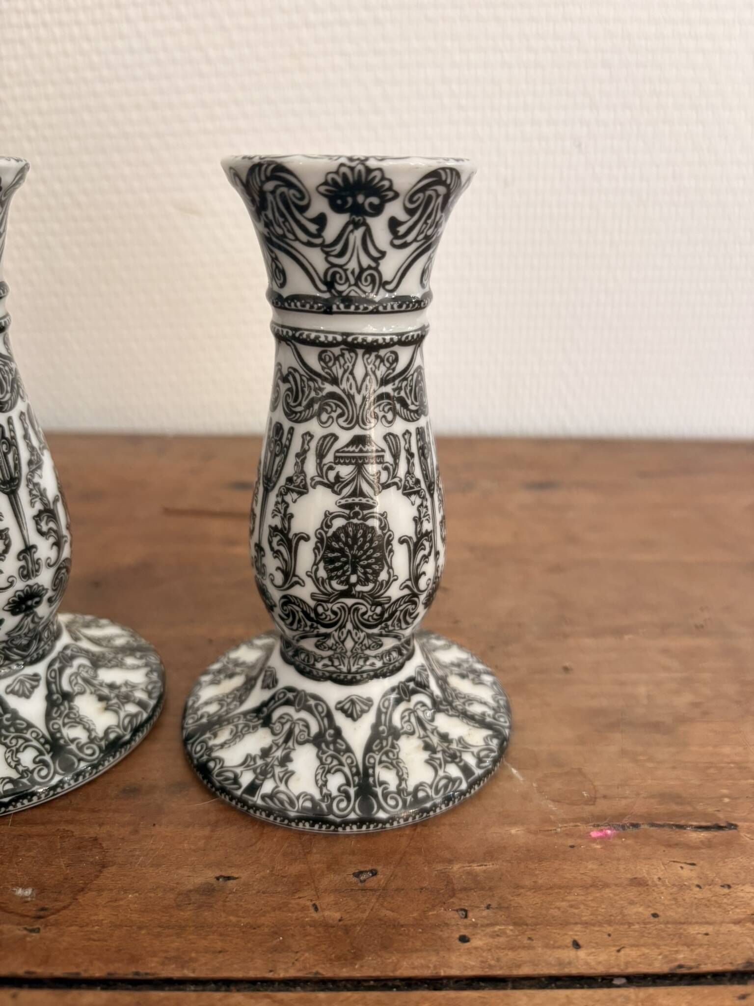 Pair of White and Black Porcelain Candle Holders with Berain Scroll Decoration, Baluster Style