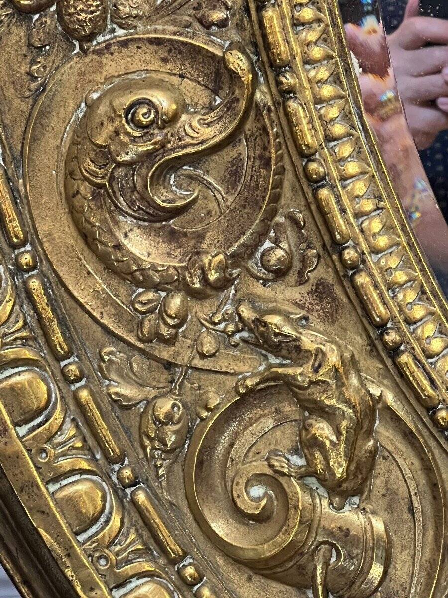 A. Arens, Antwerp, important oval mirror in repoussé brass with numerous animal decorations