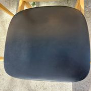 3 Scandinavian style chairs, light wood and black faux leather.