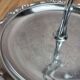 Small vintage round display stand in chrome metal – rococo style
