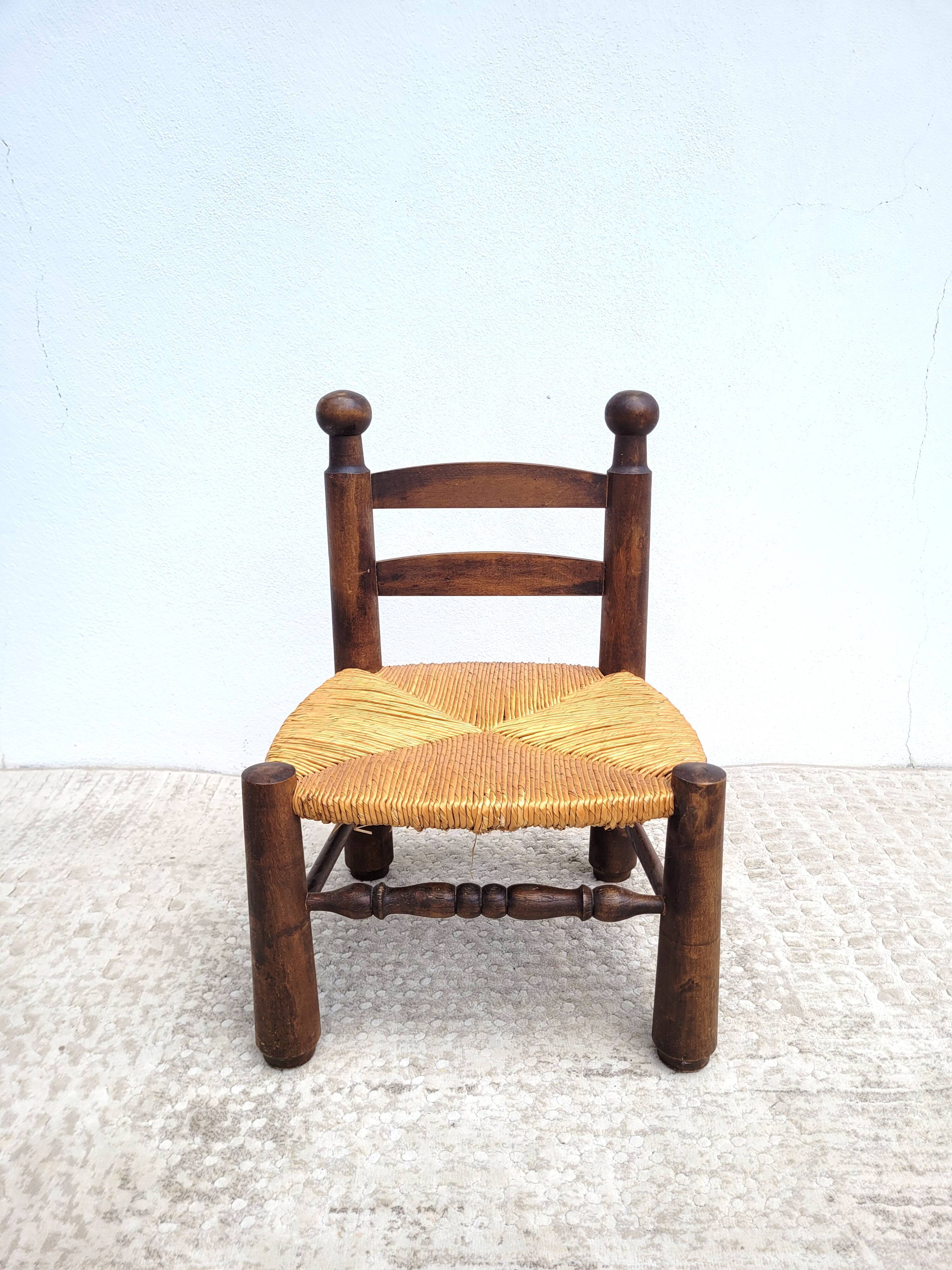Low chair in turned wood and straw