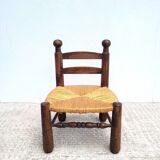 Low chair in turned wood and straw