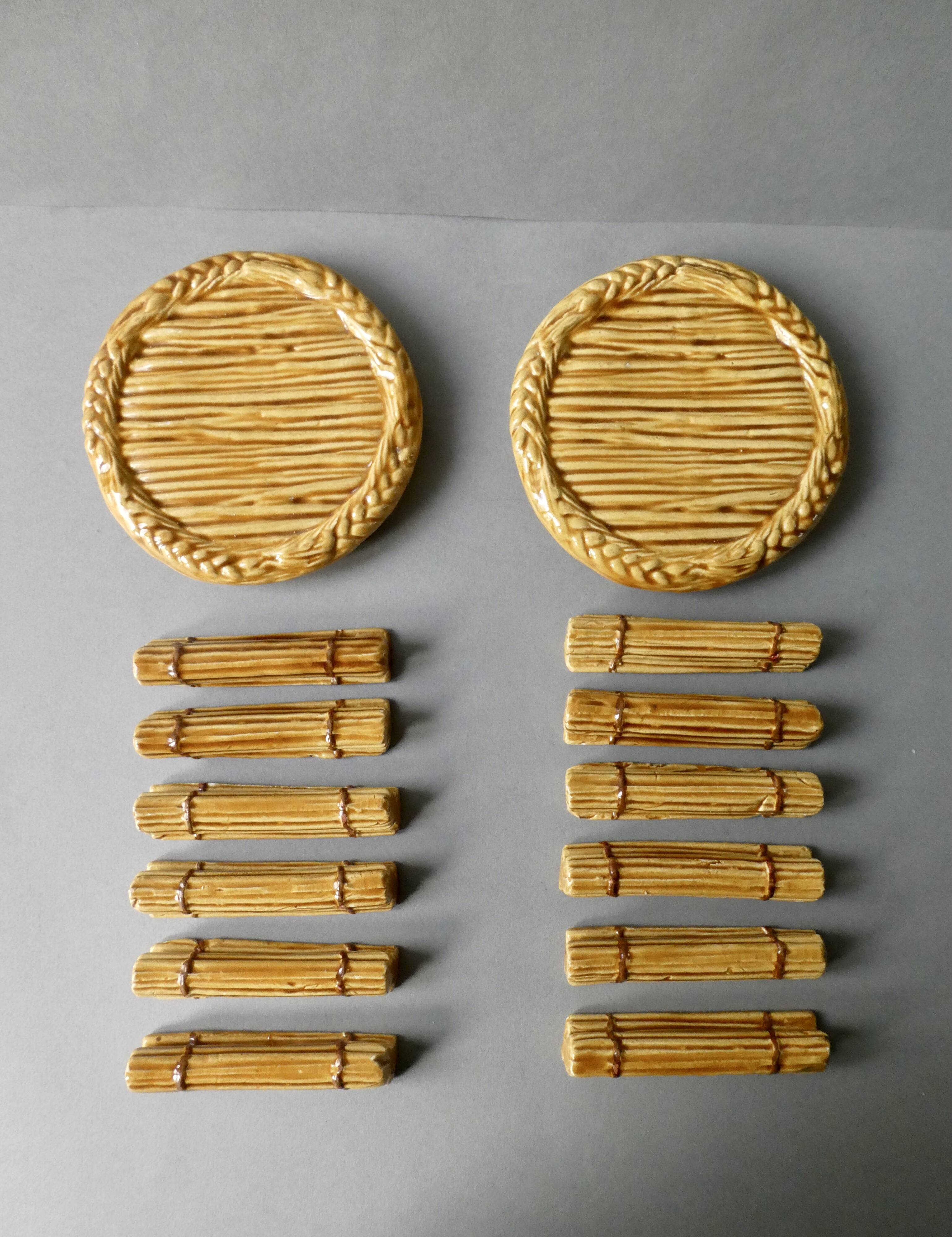 12 knife rests and 2 bottle coasters in earthenware
