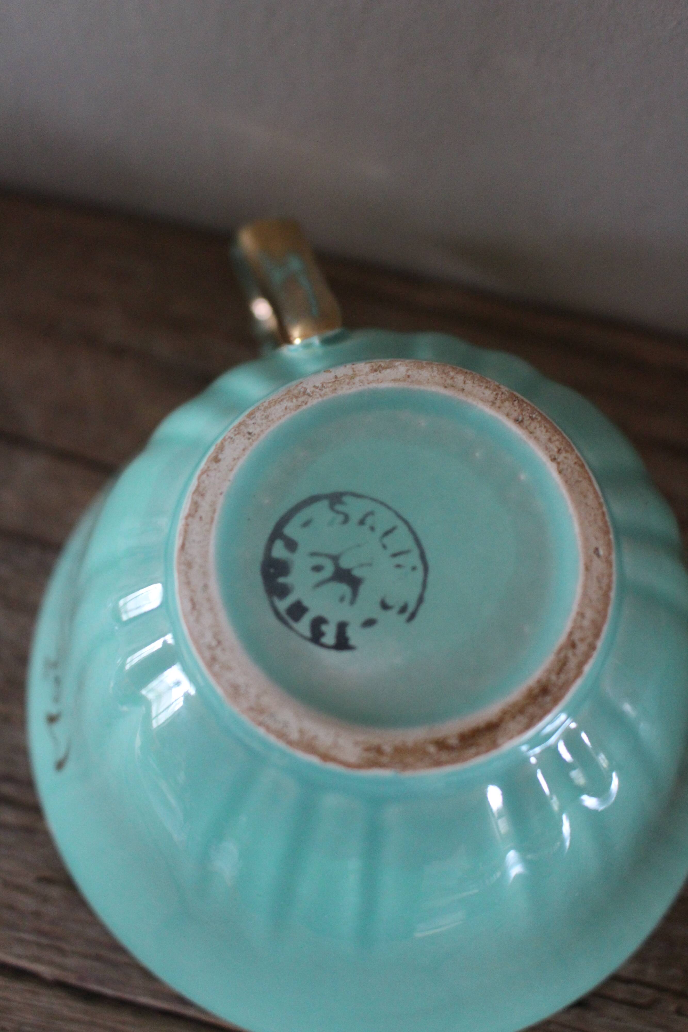 Green and gold cup from the Moi Salins collection.