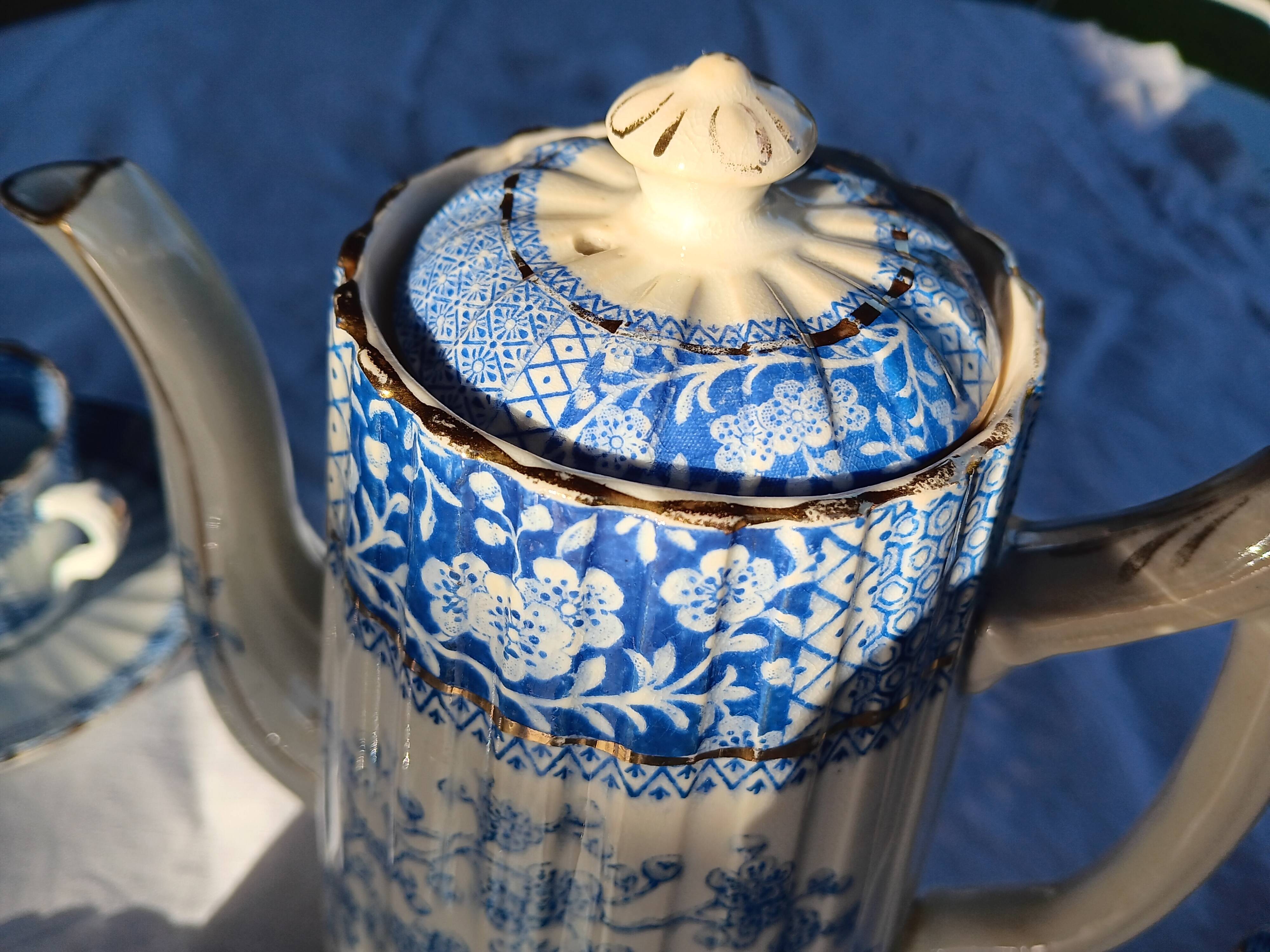 Old coffee service Lunéville with blue lace decoration.