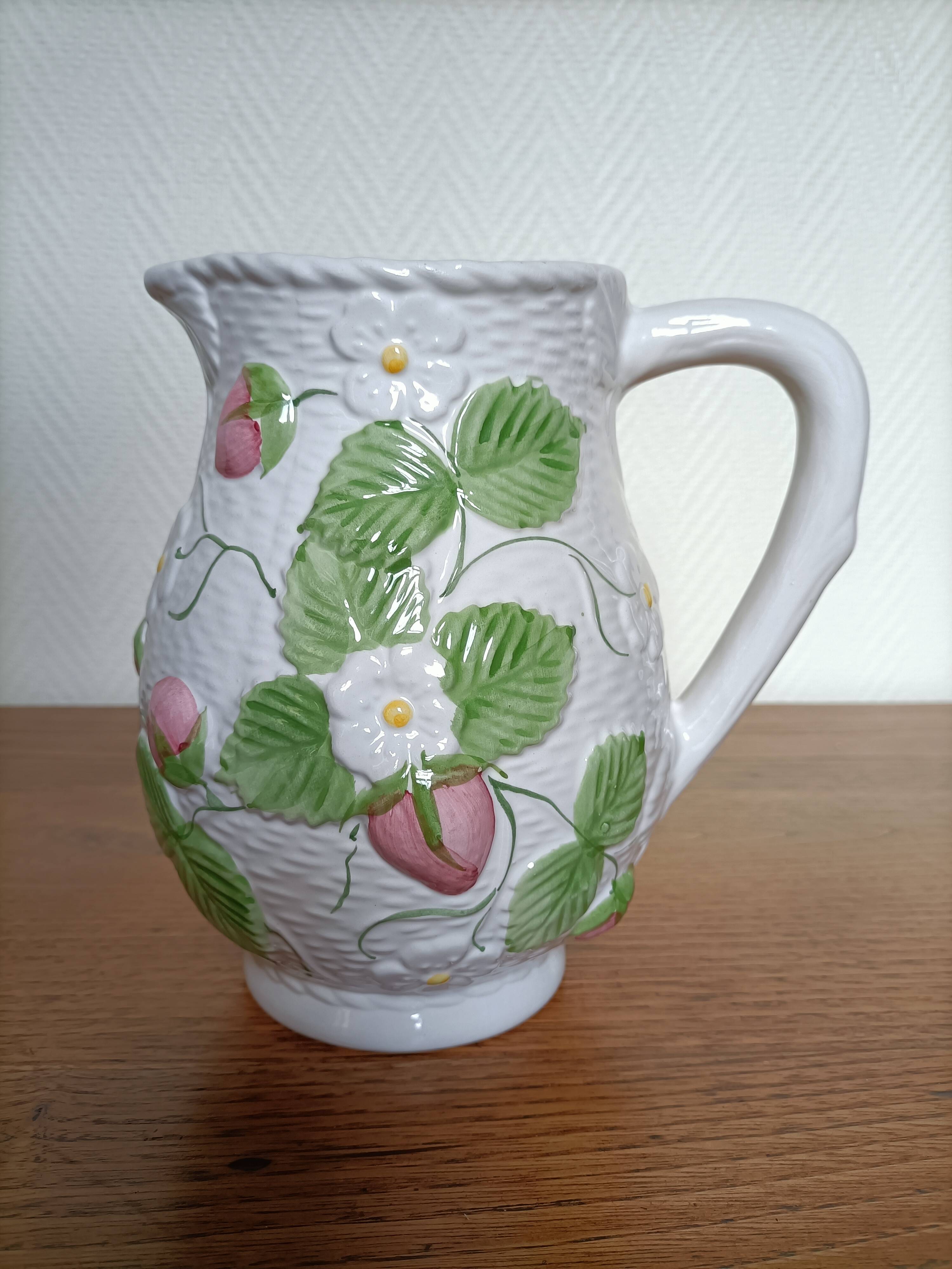 Barbotine pitcher with pastel flower decoration