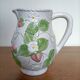 Barbotine pitcher with pastel flower decoration
