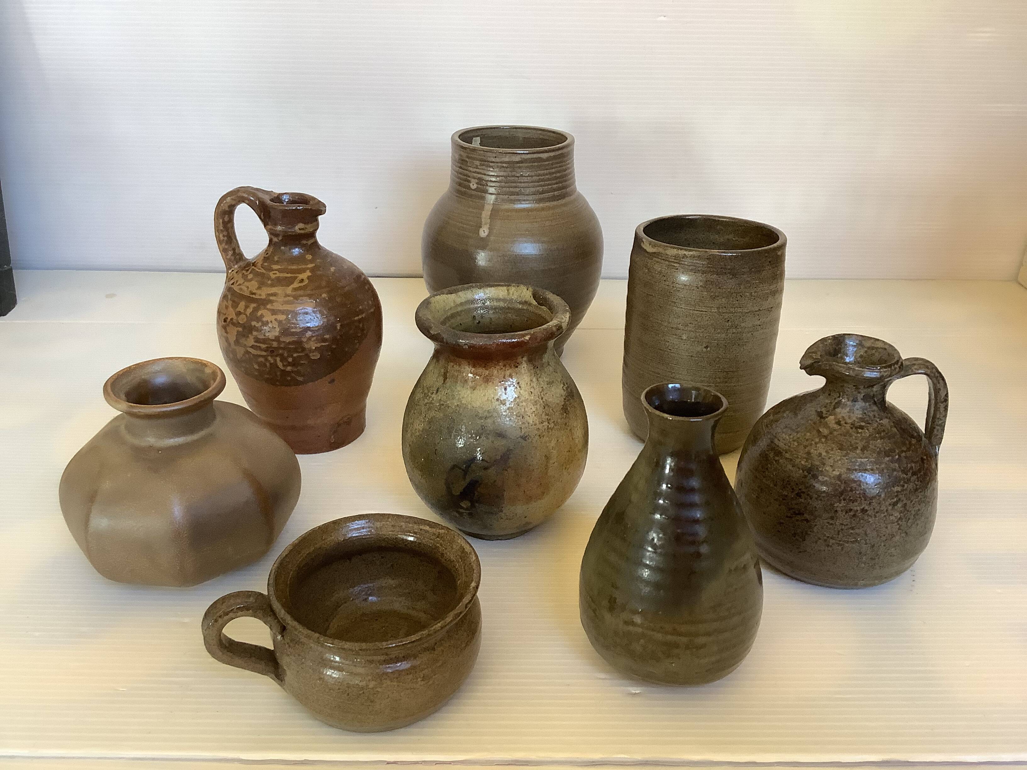 Eight brown ceramic pitcher vases