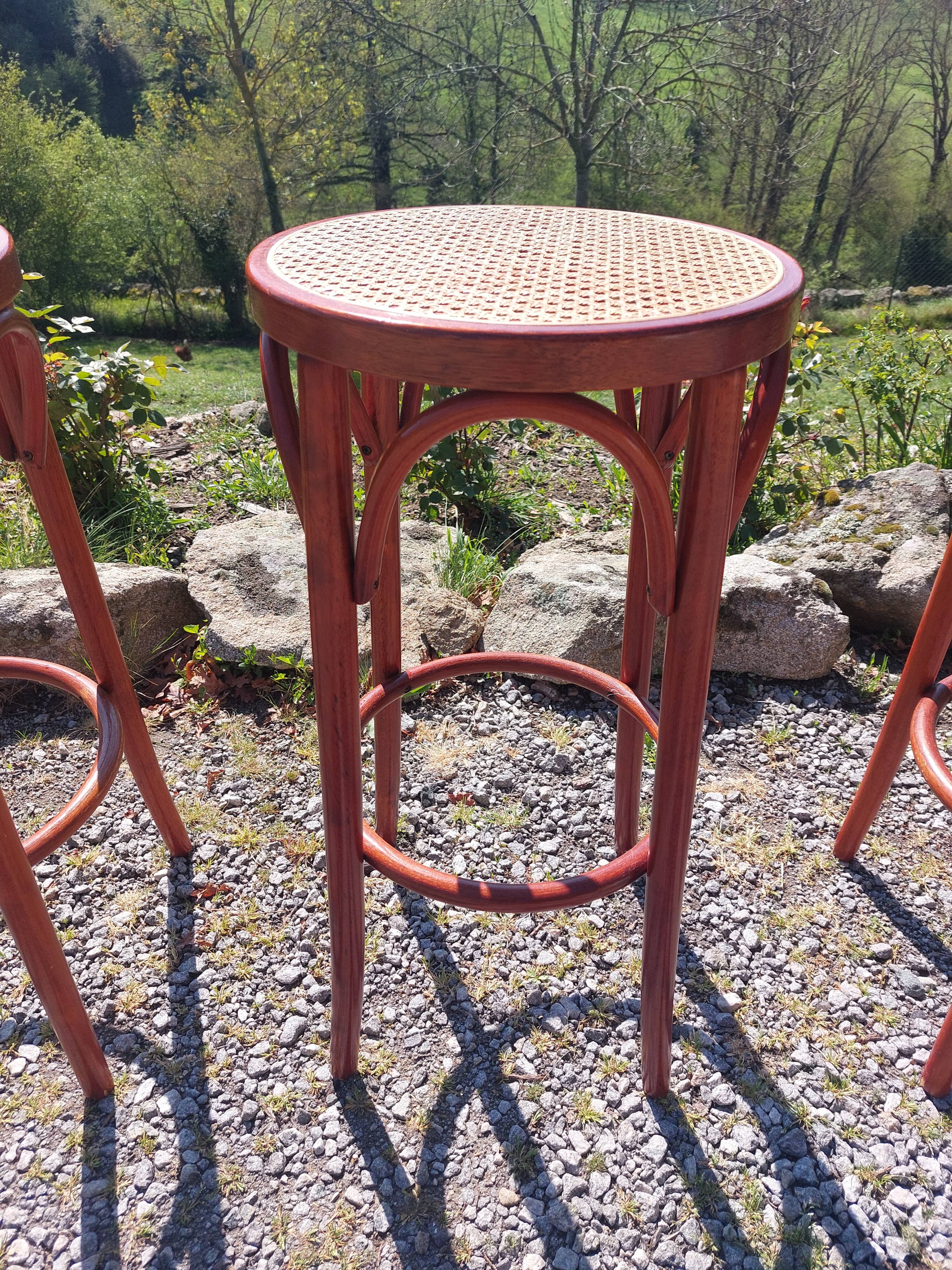 3 wooden and cane bar stools