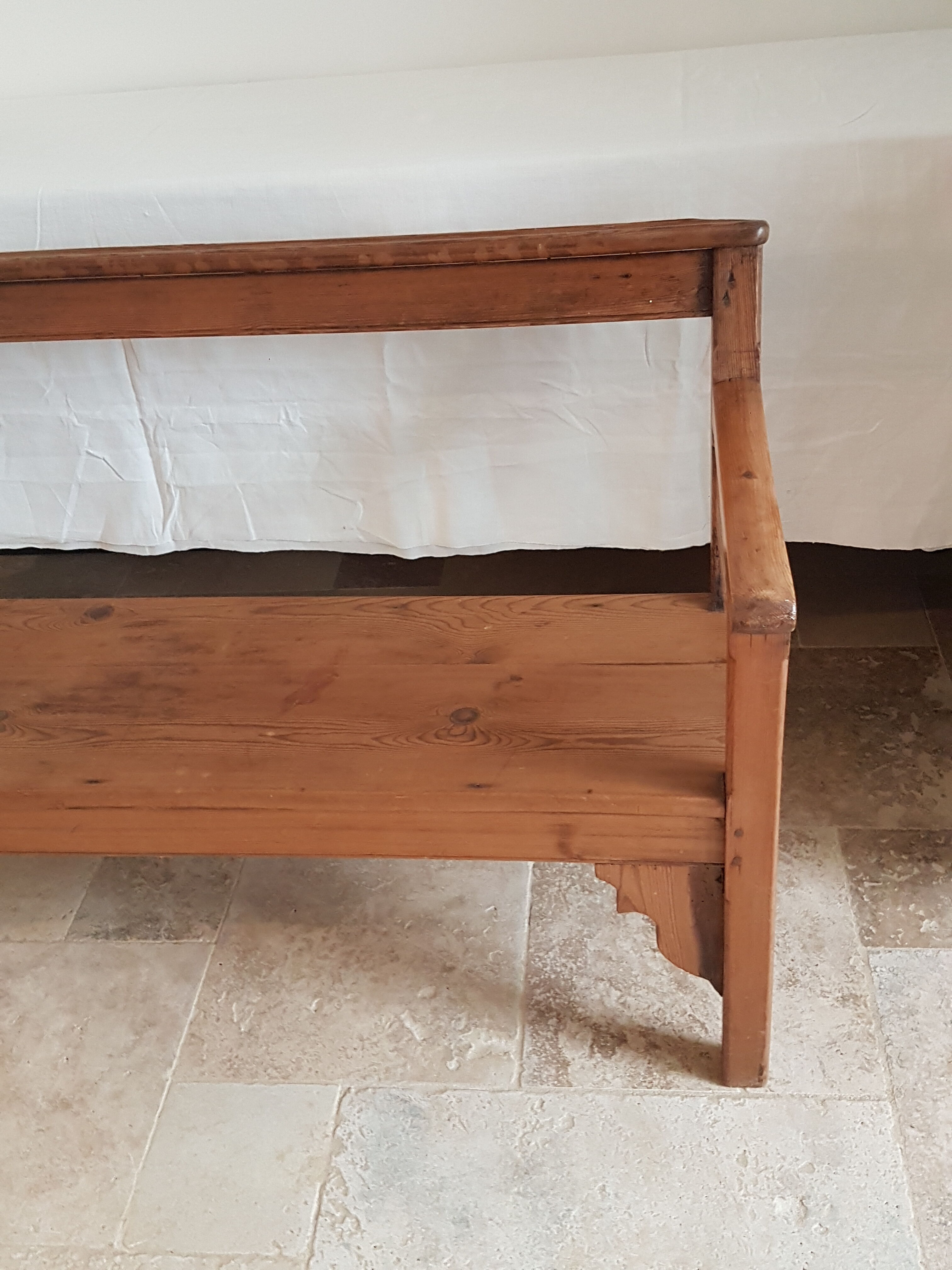 Church bench in fir tree with armrests