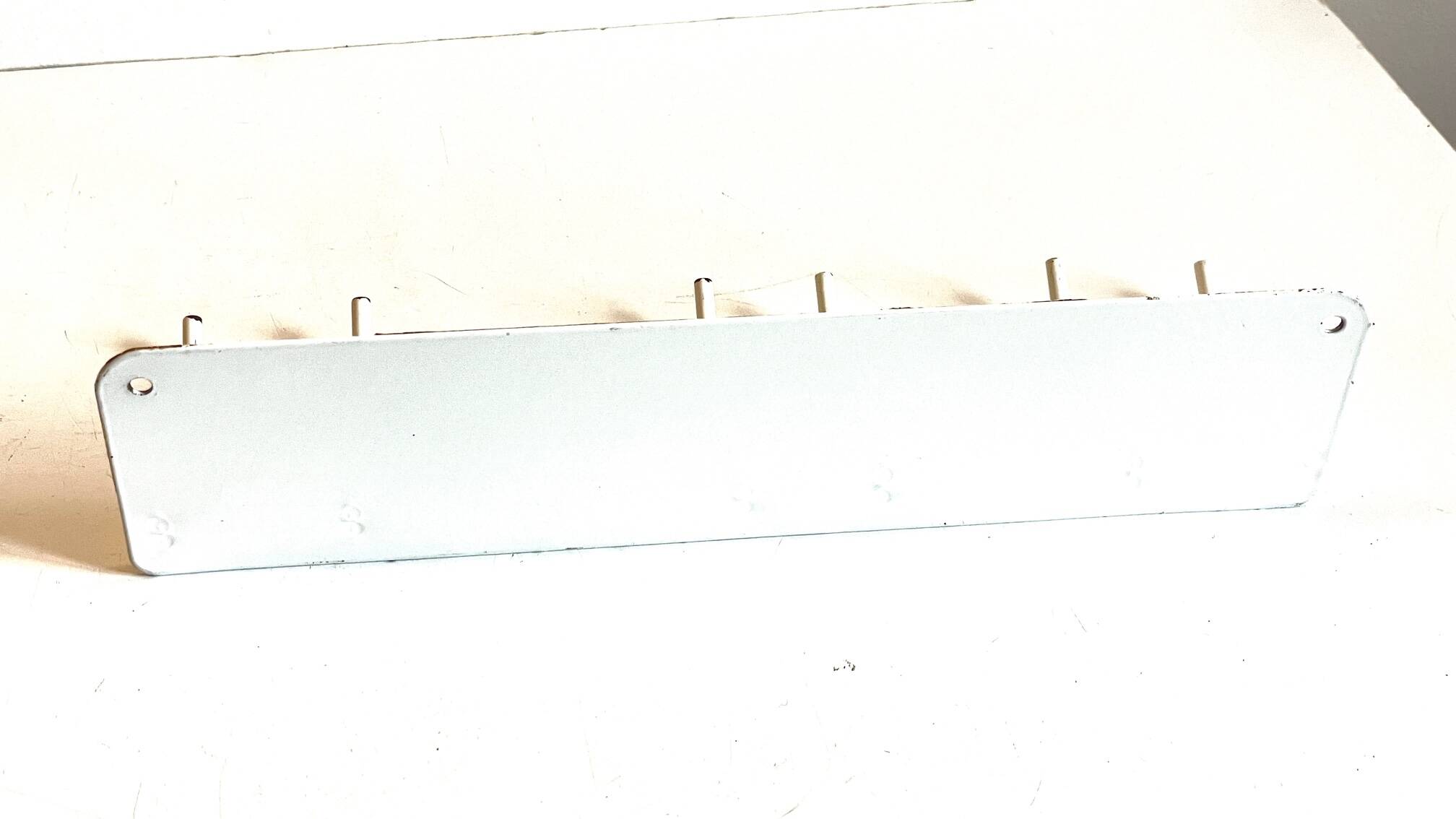 Vintage white metal wall trade coat rack