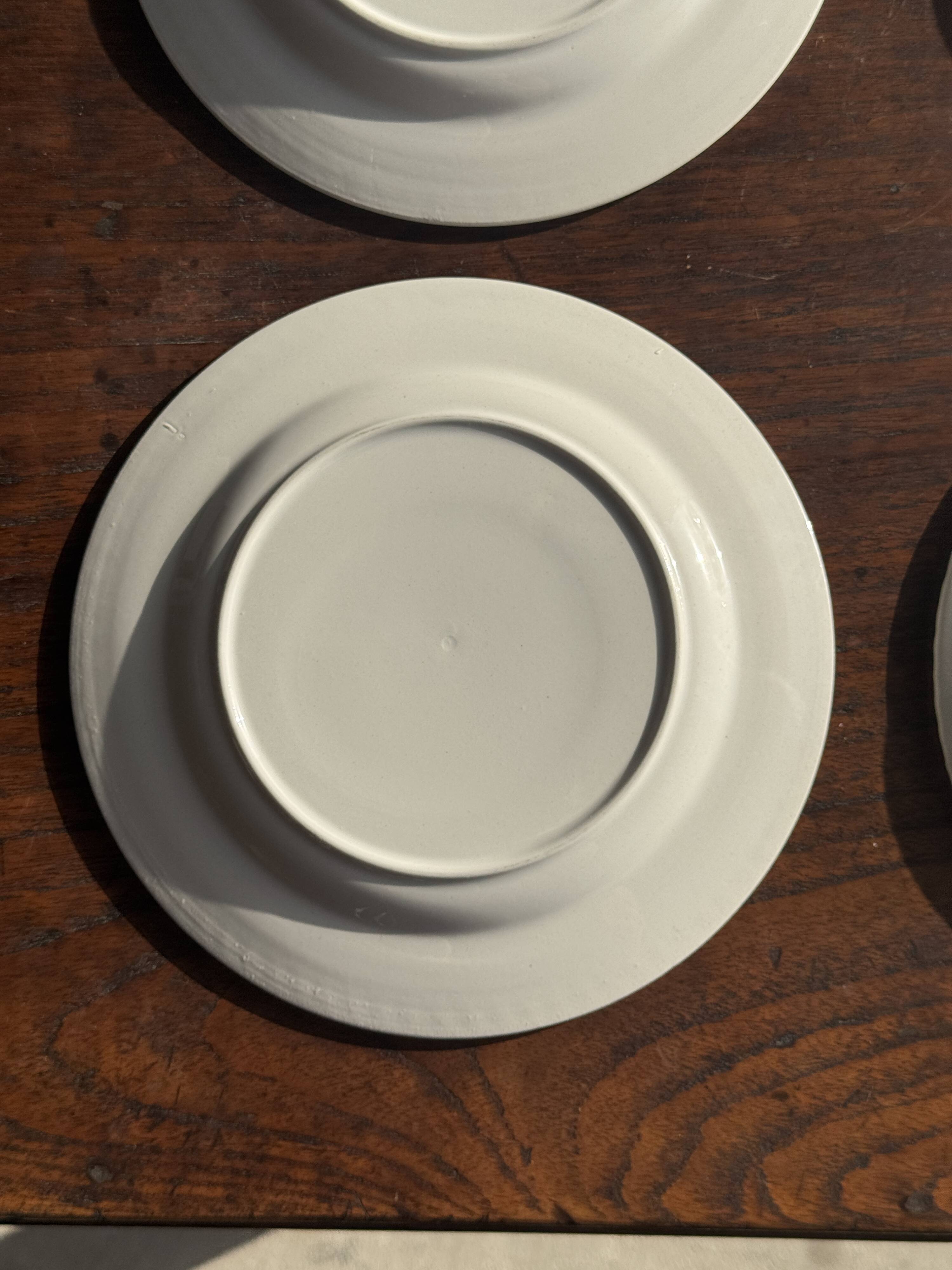 Set of 4 small dessert plates with a vintage stylised flower pattern.