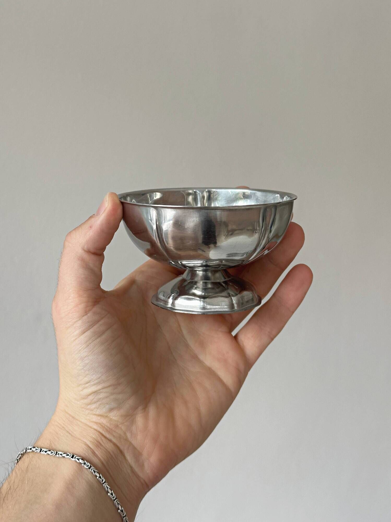 Set of 6 silver stainless steel ice cream bowls on a stand.