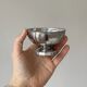 Set of 6 silver stainless steel ice cream bowls on a stand.