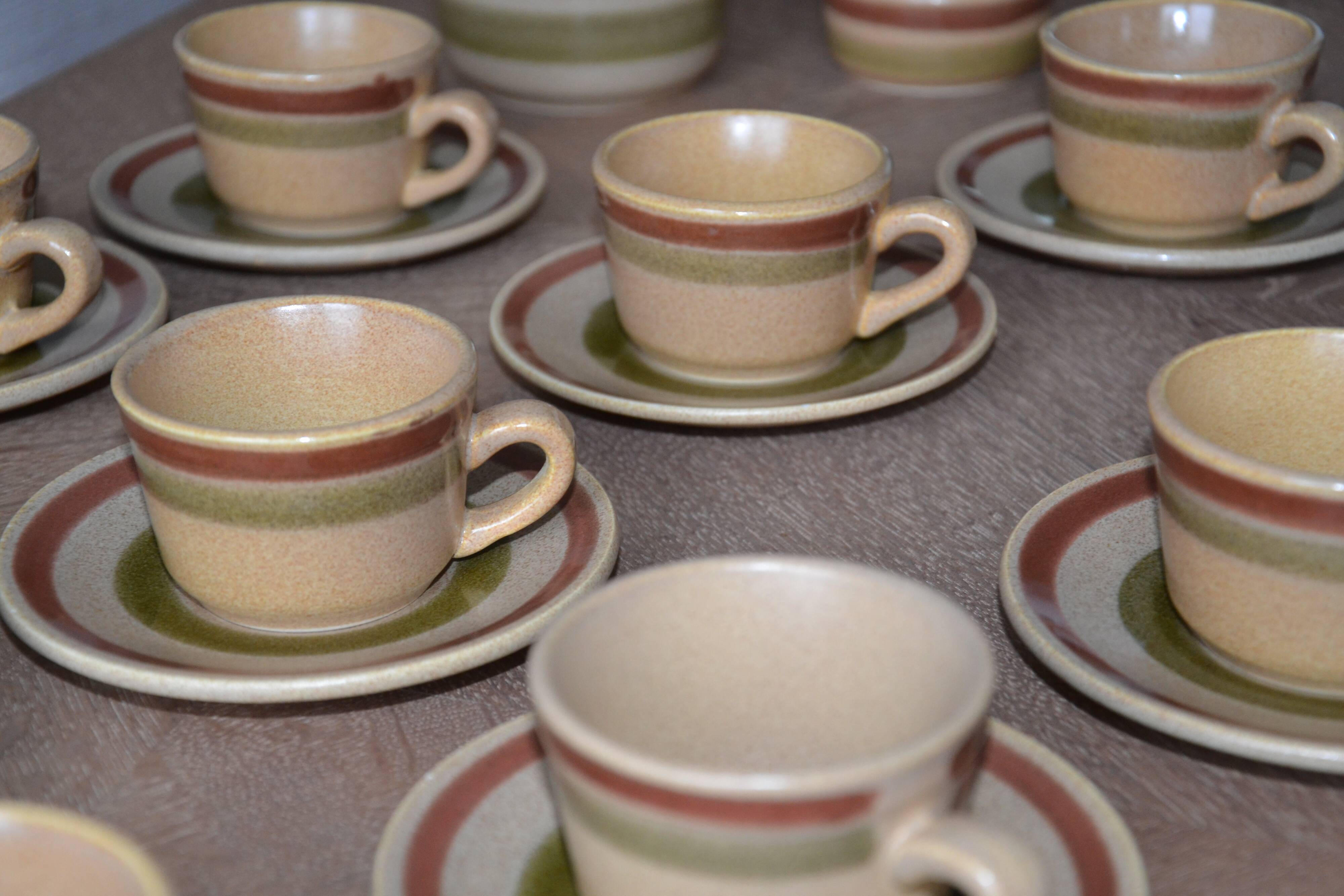 11 St Amand glazed stoneware cups and saucers/sugar bowl/milk jug