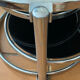 Coffee table with pivoting metal and black glass elements.